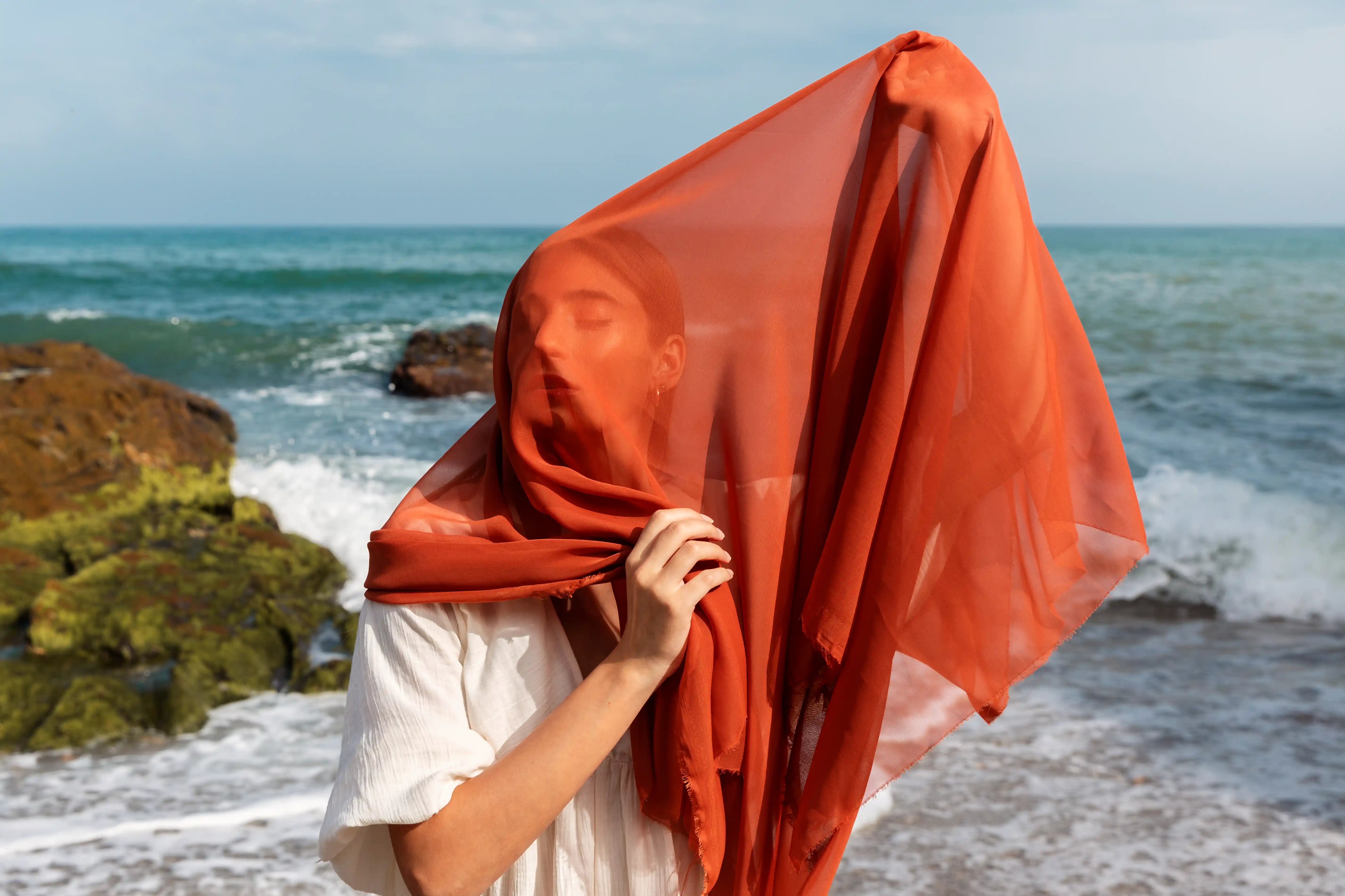 Exploring Polyester Voile Hijabs: A Practical Choice for Hajj Pilgrimage(pic1) 1 portrait-woman-beach-covering-her-face-with-veil.webp