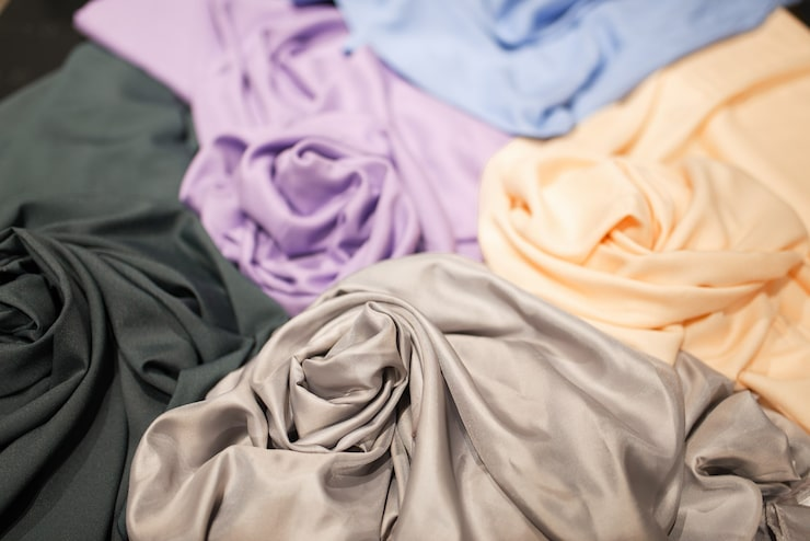 Various colored silk fabrics arranged together.png